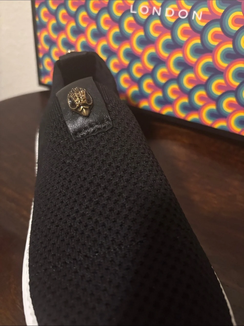 Kurt Geiger Black Knit Slip-On Sneakers with Gold Emblem